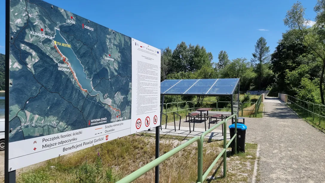 Tablica z mapą tras nad Jeziorem Klimkowskim i miejsce odpoczynku przy ścieżce